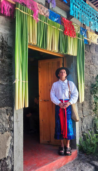 Apab'yan Tew standing in front of a door.