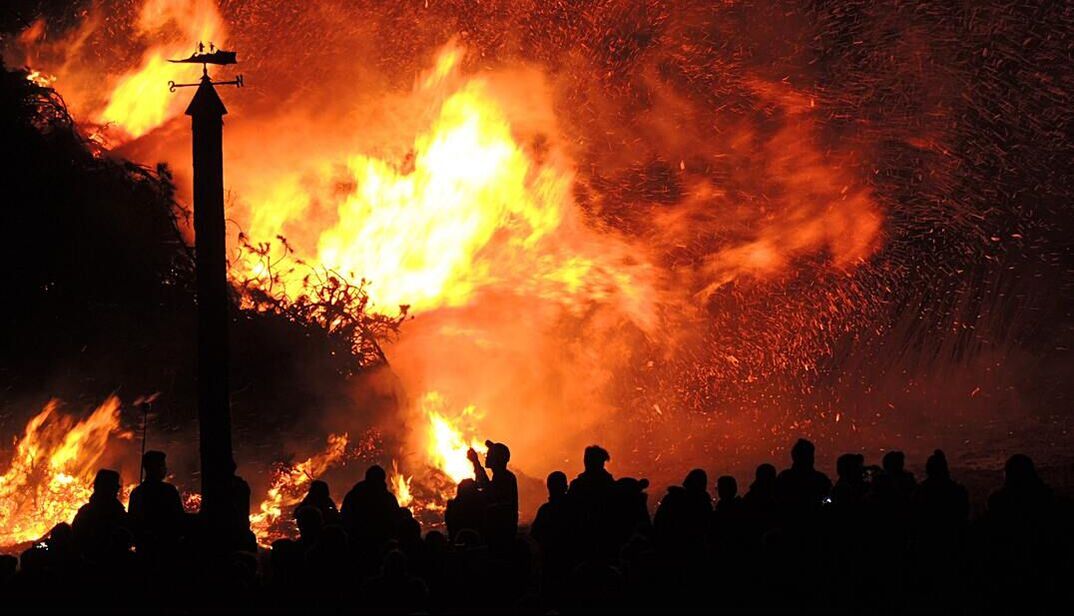 a wild fire and a crowd of people